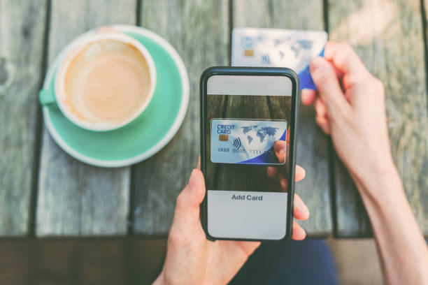 istock Woman adding credit card into digital wallet 1320667921