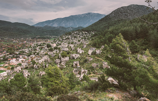 Abandoned Greek Village Kayakoy in Turkey ander gloomy sky