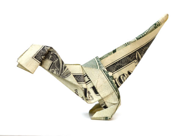 istock Origami dollar dinosaur (velociraptor) on white 1320672976