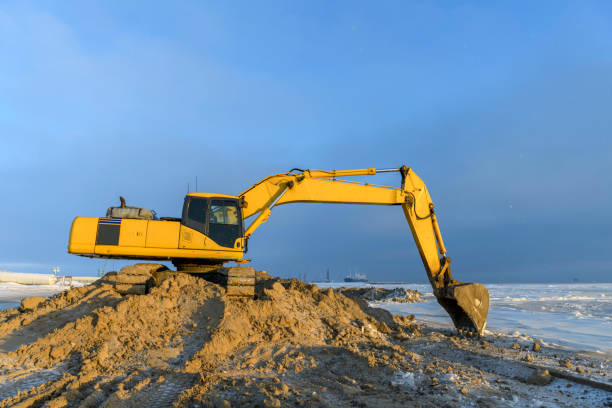 istock Yellow excavator working on construction site. The road construction. 1320674226