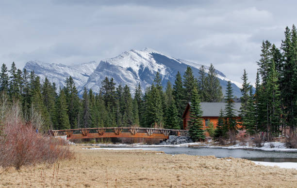 istock Canmore, Spring Creek, wooden bridge & Rocky Mountains 1320676164