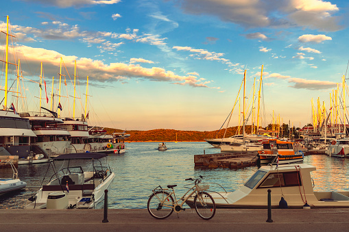 Beautiful viiew of marina with boats and bicycle at sunset, Korcula, Croatia.