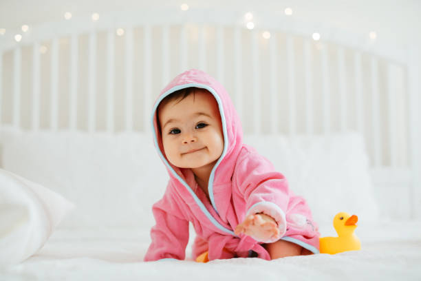 istock Baby girl in pink bathrobe 1320677768