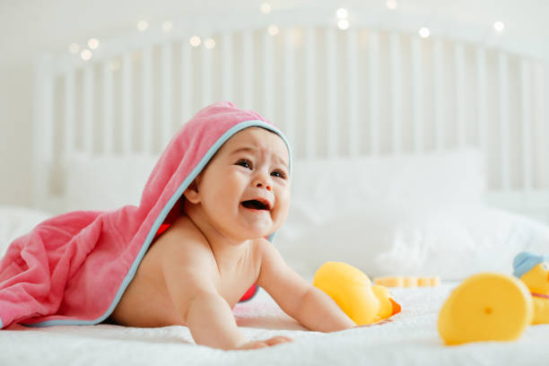 istock Baby girl in pink bathrobe 1320677829