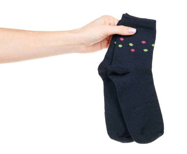 istock Hand with dark blue cotton socks isolated on white background 1320677843