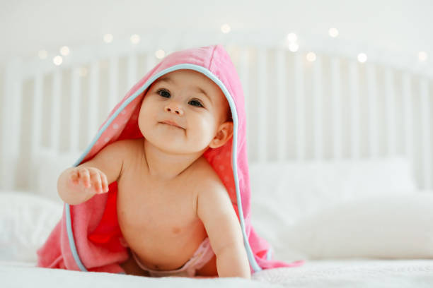 istock Baby girl in pink bathrobe 1320677848