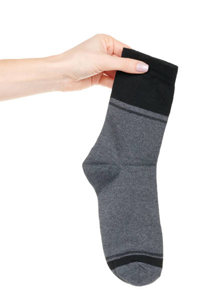 istock Hand with dark cotton socks with pattern isolated on white background 1320677851