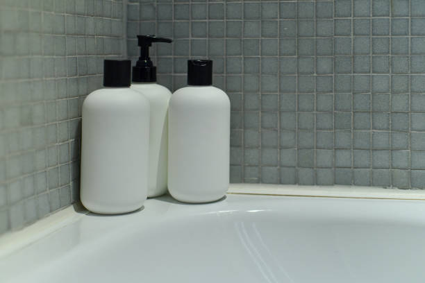 Hotel, lotion and bottle of soap in bathroom at luxury accommodation for travel, vacation or holiday. Hospitality, health and closeup of liquid products in washroom at classy lodge for weekend trip.