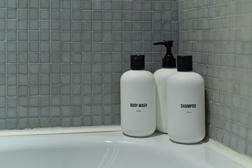 Bottles of soap and shampoo in the bathroom shower