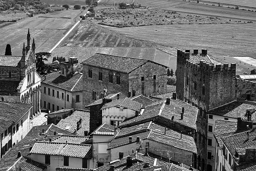 View of the houses and the church from the castle tower of the city of Massa Maritima in Tuscany, monochrome