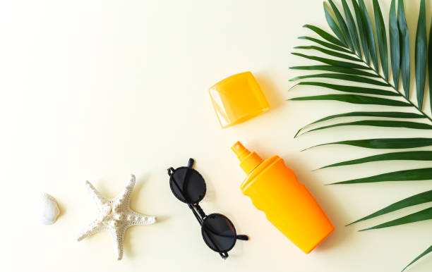Summer holiday background with sunscreen palm leaf and accessories top view Summer holiday background with sunscreen cosmetic, palm leaf and accessories top view shell starfish orange sea stock pictures, royalty-free photos & images