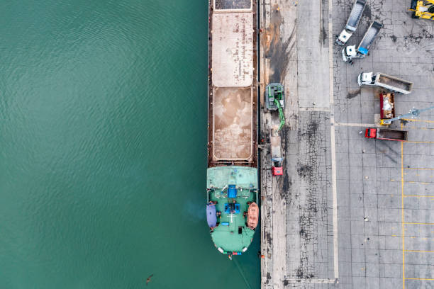 istock Crane loading trucks in an international port. 1320679671