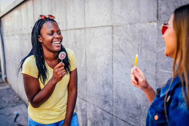 istock Women tasting colorful candies 1320681862