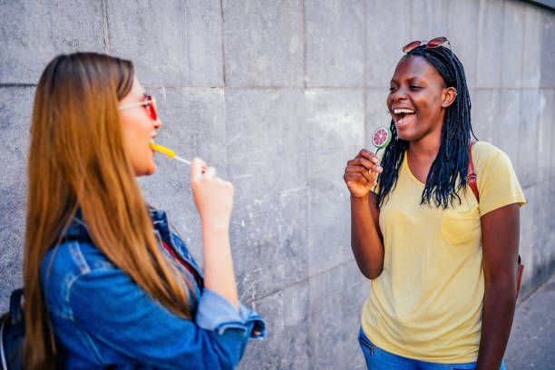 istock Women tasting colorful candies 1320681904