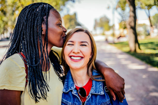 istock Multiethnic girlfriends kissing outdoor 1320682045