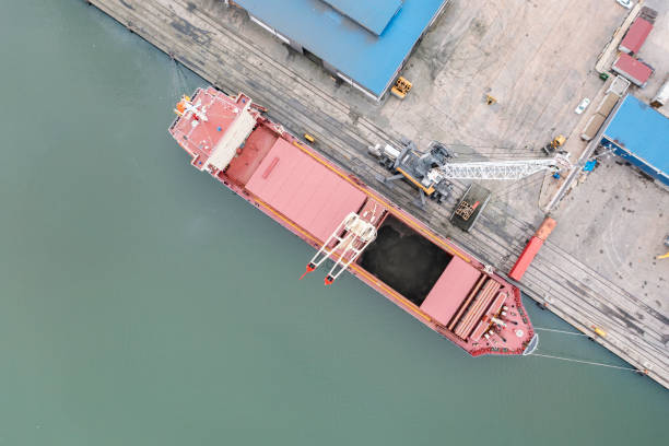 istock Unloading cargo ship in an international port. 1320682164
