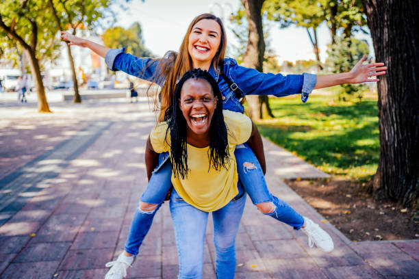 istock Laughing girlfriends having fun together in the park 1320682952