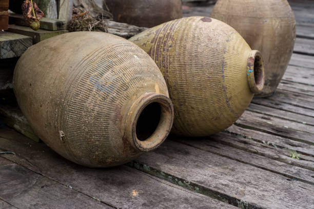 Old jars Row of old clay jars on wooden floor earthenware stock pictures, royalty-free photos & images
