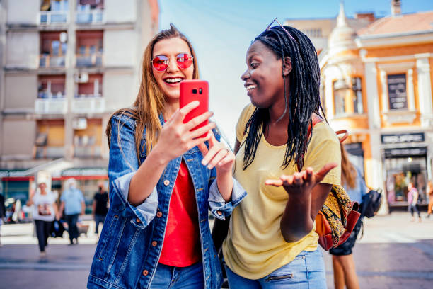 istock Female friends looking at mobile phone 1320683142