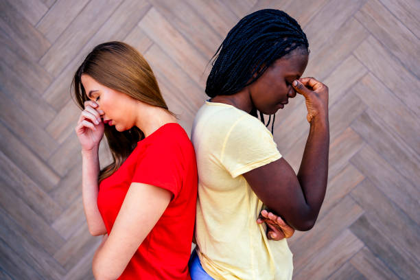 istock Unhappy female friends standing back-to-back 1320683407