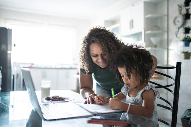 istock Mother helping daughter with homework 1320684258
