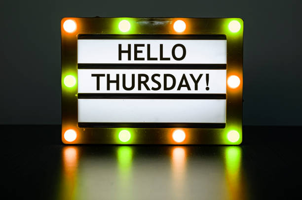 istock Lightbox with yellow and orange lights in dark room with words - Hello Thursday! 1320686065