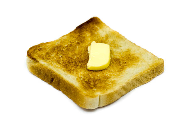 istock Toast bread with butter isolated on white background 1320686334
