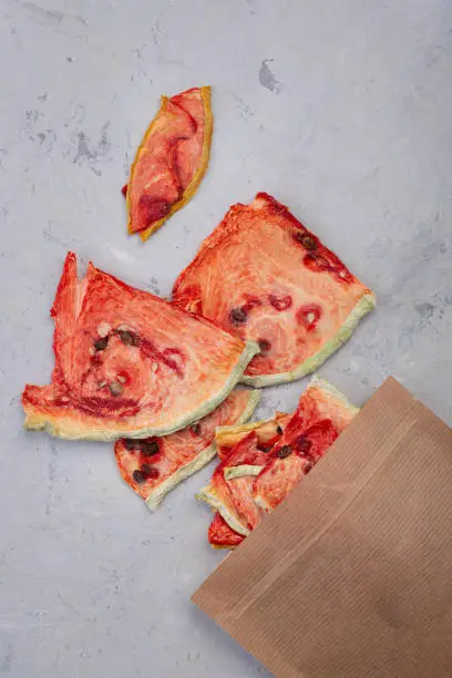 Photo of slices of dried watermelon on a concrete background