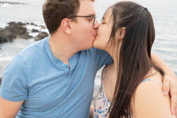 istock couple in love kissing each other while spending time outdoors on seaside 1320691312