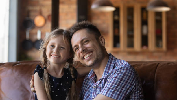istock Happy daddy and little daughter kid sitting together 1320693218