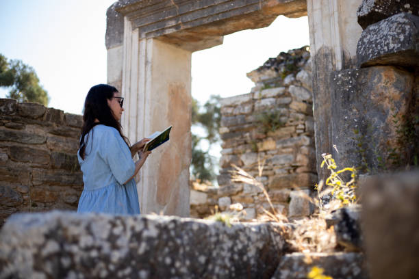 istock Woman reading guide book at the ancient city 1320694896