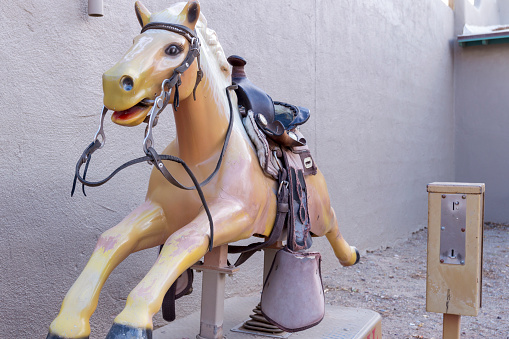 This old mechanical horse ride required coins to put it in motion.  It is now located at a tourist destination as a nostalgic symbol.