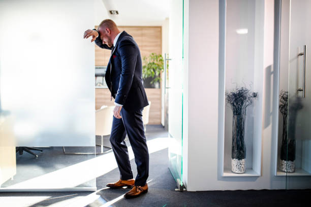 istock Tired businessman in his modern office 1320697322