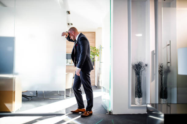 istock Tired businessman in his modern office 1320697864