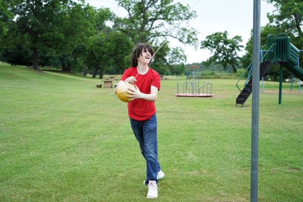 istock Teen Boy Plays Tether Ball on Playground 1320699018