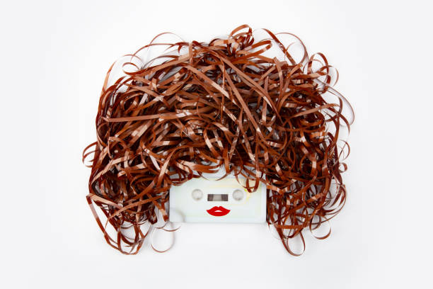 istock Funny female Face with old school Audio Tape 1320704710