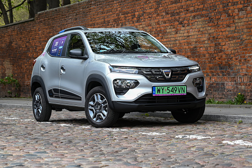 Warsaw, Poland - 4th May, 2021: Electric car Dacia Spring (Renault brand) in carsharing system on a street. This model is the first mass-produced electric car from Dacia.