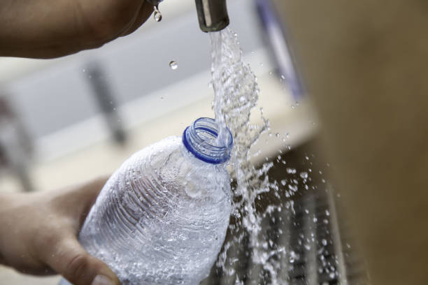 istock Filling bottle in fountain 1320706753