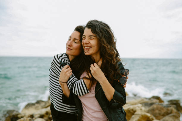 Female friends enjoy walking the beach