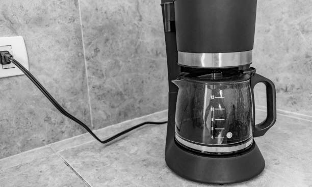 istock Black coffee maker from Mexico on cream background in clean kitchen Black and white picture. 1320709069
