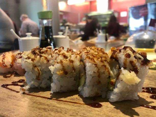 istock Salmon, avocado and cucumber sushi roll with teriyaki sauce 1320714801