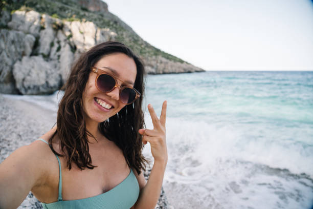 istock Young woman relaxes on Mediterranean beach 1320716661