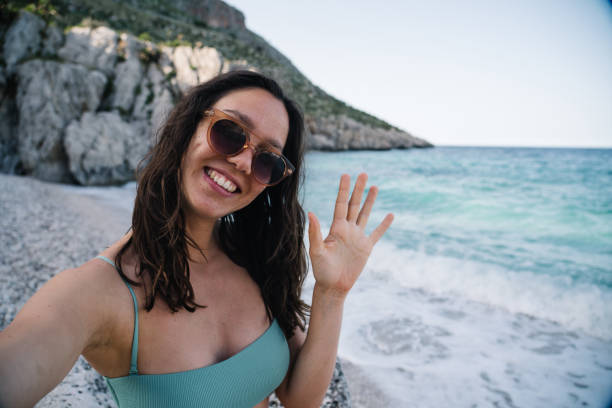 istock Young woman relaxes on Mediterranean beach 1320716681