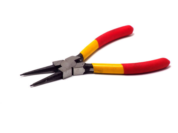Picture of snap ring plier that has a yellow - red handle Picture of snap ring plier that has a yellow - red handle. Shoot on white isolated background. orbis stock pictures, royalty-free photos & images