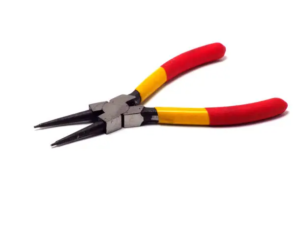 Picture of snap ring plier that has a yellow - red handle. Shoot on white isolated background.