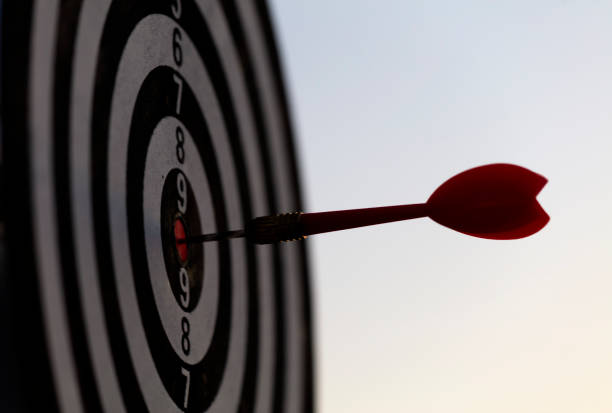 istock Close up shot red darts arrows in the target center 1320721477
