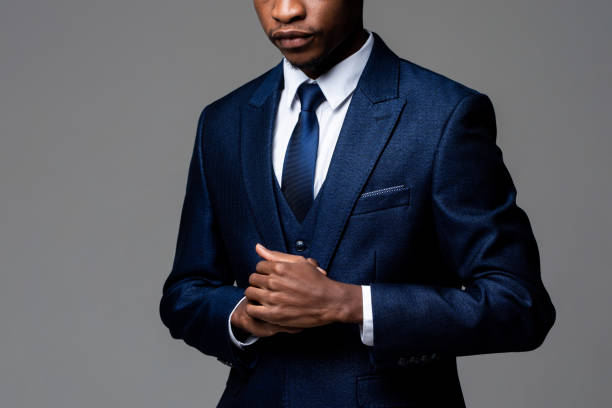 istock Anonymous young African man wearing formal business suit in studio gray isolated background 1320722474