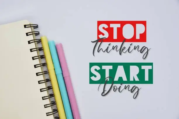 Photo of 'Stop thinking, start doing' quote on the white background