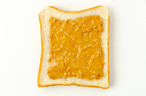 istock peanut butter on a slice of white bread. 1320724534