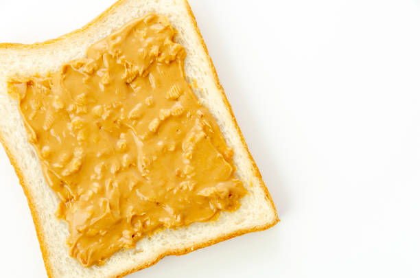 istock peanut butter on a slice of white bread. 1320724611